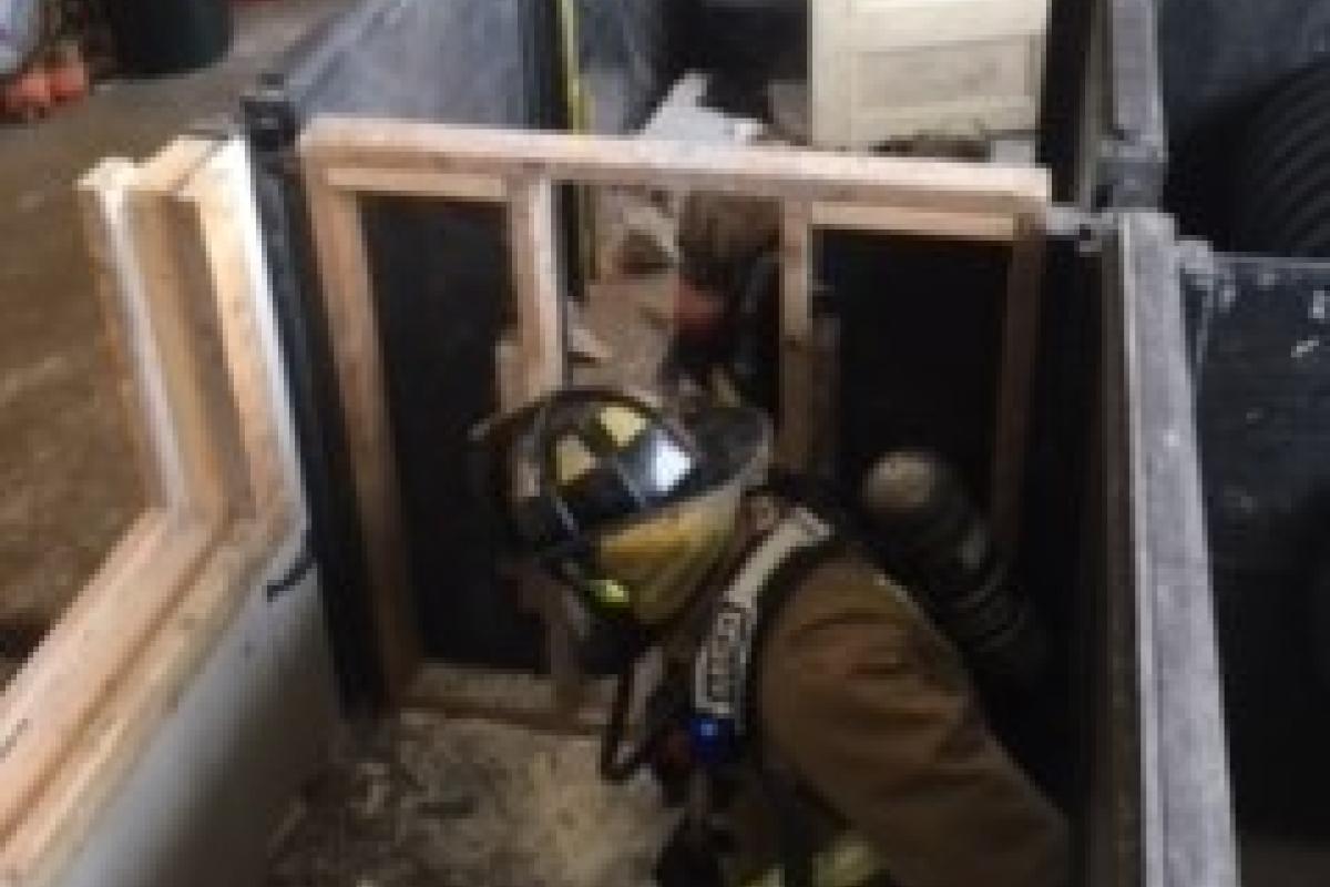 Firefighters continuing through the wall