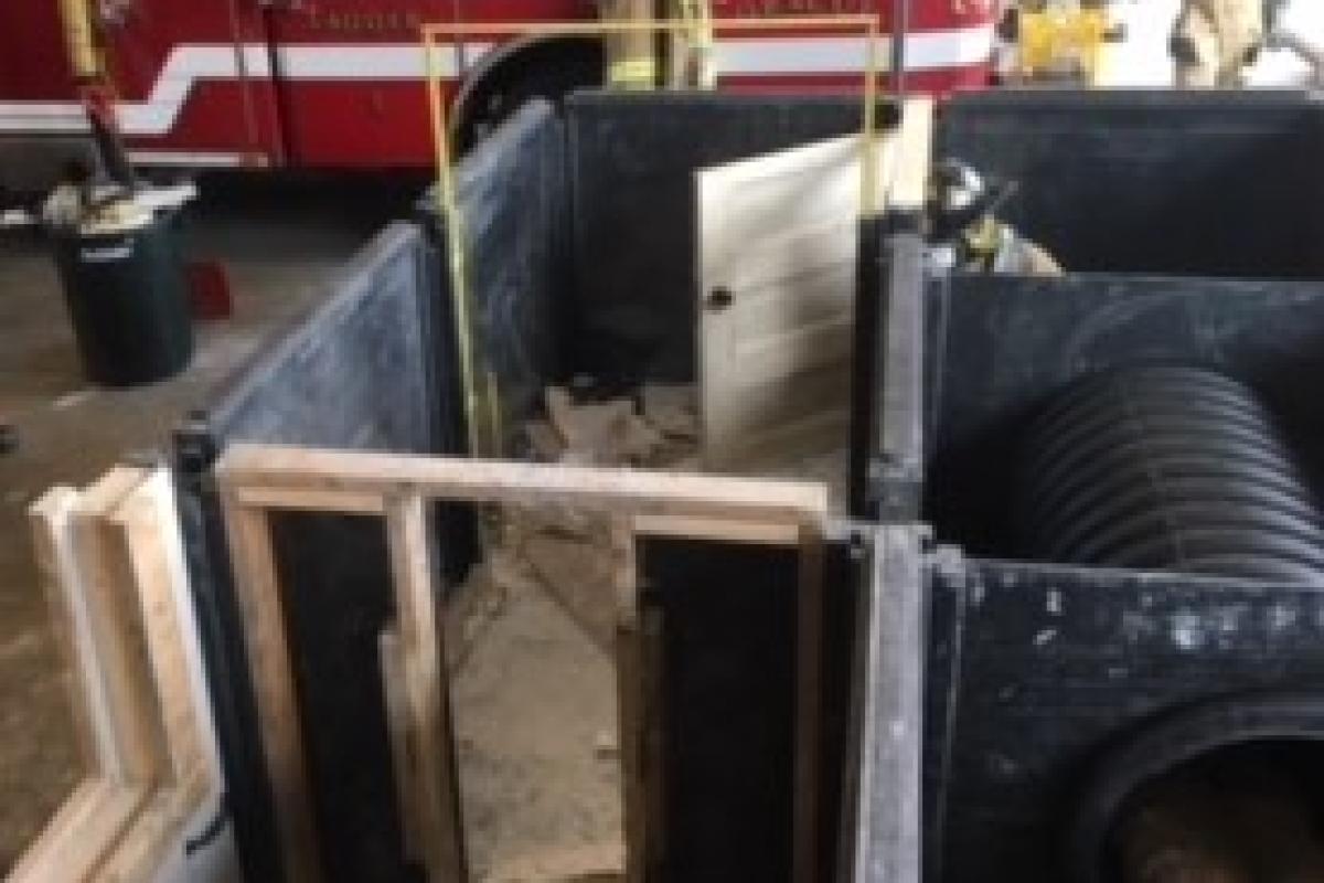 Firefighters entering a room to continue search