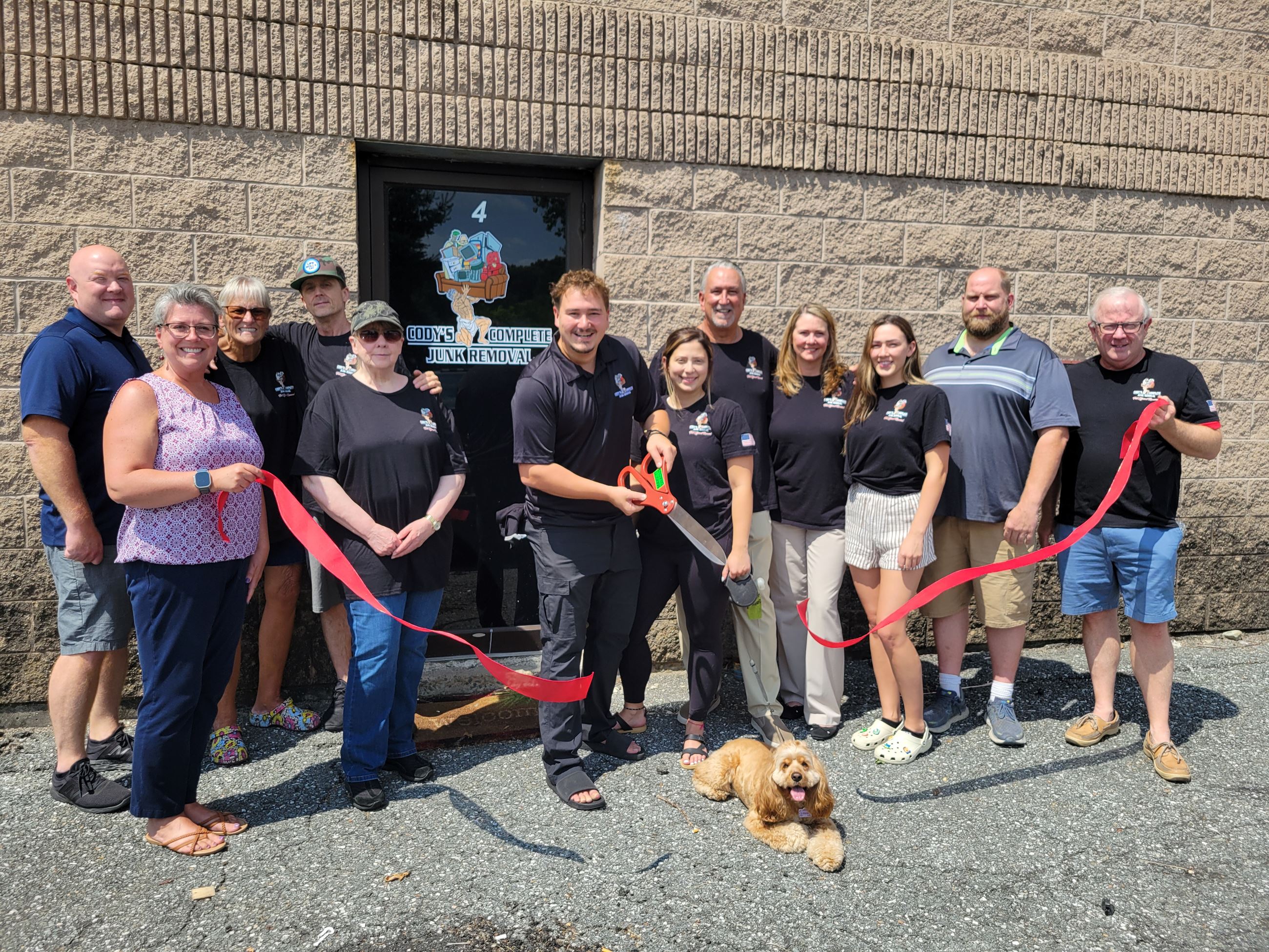 Cody Kuenzler cuts the ribbon surrounded by family, friends and Dracut officials.